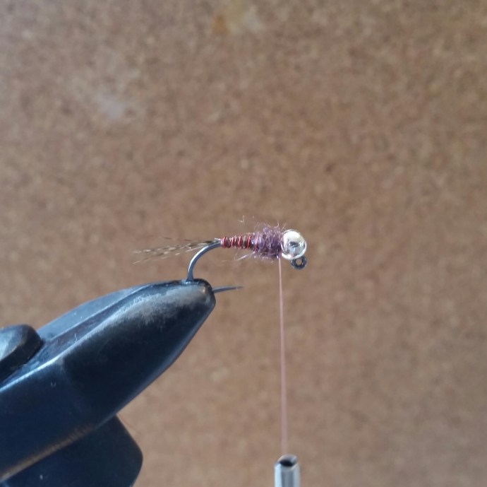 Dub your thread with the UV Ice Dub. Don't go too crazy here, ice dub becomes more straggly once it has been cast a few times. We're looking to create enough bulk for the cdc to back up against.